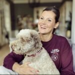 Smiling owner wearing a Lagotto Mum Club shirt with her dog Falco.