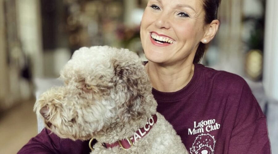 Smiling owner wearing a Lagotto Mum Club shirt with her dog Falco.